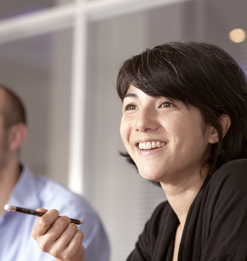 Woman holiding pen in meeting